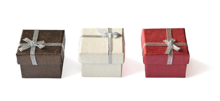 Three gift boxes with silver ribbon isolated on whiteの写真素材