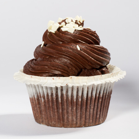 chocolate cupcake with white chocolate sprinkle decoration, side viewの写真素材