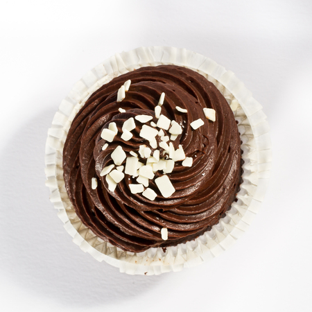 chocolate frosted cupcake with white chocolate decoration, view from aboveの写真素材