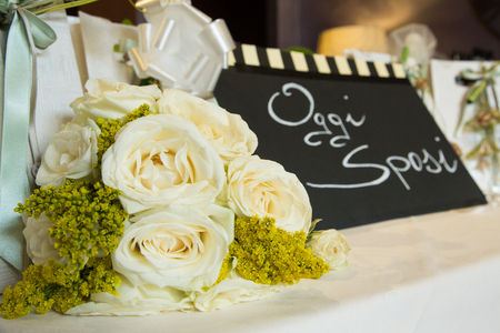 white and yellow flower bouquet with black signの写真素材