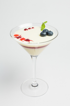 Panna cotta with fresh blueberries and mint, layered with jamの写真素材