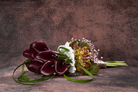 Flower composition made of black calla lily, lady Slipper Orchid Paphiopedilum and pink Gypsophila, drops on itの写真素材