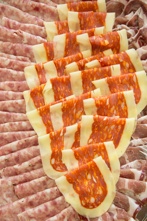 tray with different italian types of spicy salami, seen from aboveの写真素材