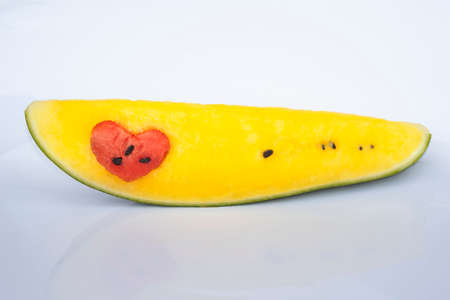 juicy yellow watermelon with a heart of red watermelonの写真素材