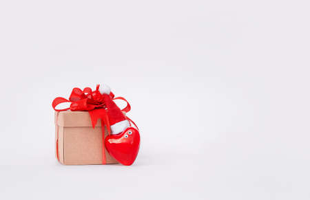 red heart in santa hat and gift box on white backgroundの写真素材