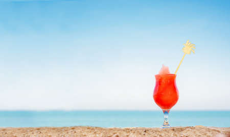 fruit juice on the beach. fresh watermelon on the sand against the backdrop of a seascapeの写真素材
