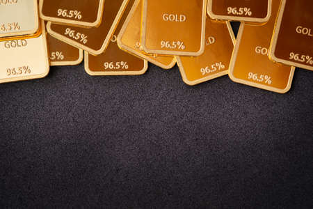 Gold bars on a black background. Stability concept. Gold ingot backgroundの写真素材