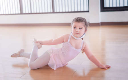 Girl child learning to dance ballet in classの写真素材