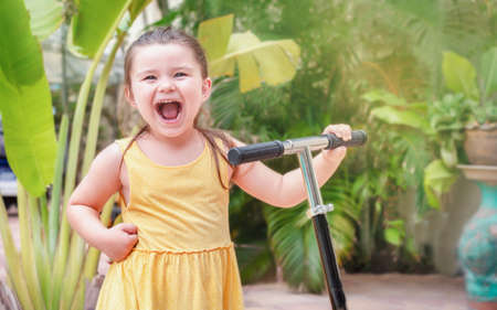 Woman with balloons on yellow background at partyの写真素材