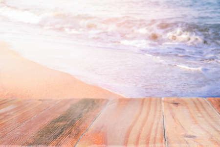 Wooden surface on the sea beach at sunset.