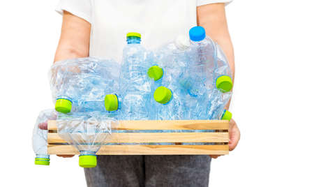 Woman holding a wooden box with blue plastic bottles isolated on white background. Recycling