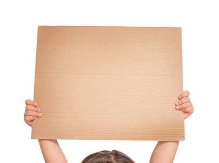 Child hands hold cardboard poster above head isolated on white backgroundの写真素材