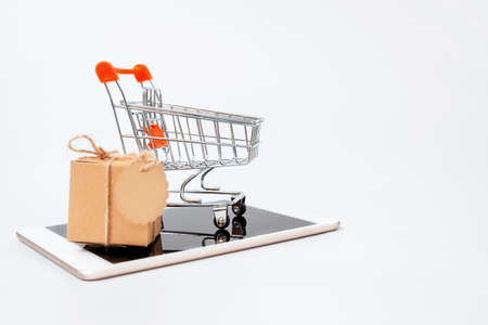 Gift box and shopping cart on the tablet. Online shoppingの写真素材