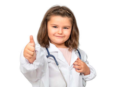 Portrait of child in doctor costume with stethoscope and thumbs up isolated on white backgroundの写真素材