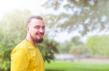Portrait of happy man with beard on nature outdoorの写真素材