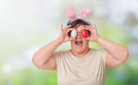 Plus size woman with easter eggs in nature