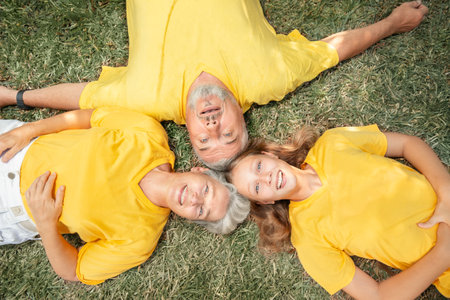 Top view happy family portrait lies on the grassの写真素材