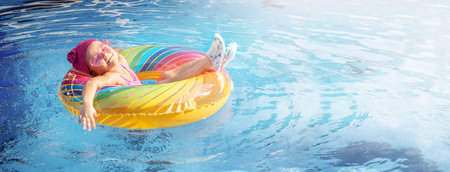 Satisfied child resting in an inflatable ring in the pool