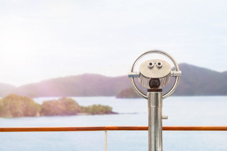 Binoculars on the deck of a cruise ship with a view of the sea and islands