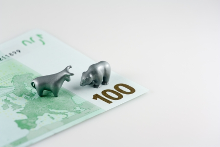 This photo shows the fragment of one hundred euro and the metal bear and the metal bull like symbol of stock gamblers の写真素材