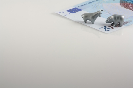 The photo shows the twenty euros and metal figures of bull and bear の写真素材