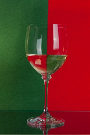 The photo shows the glass of wine on the background of two colors.の写真素材