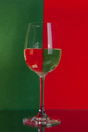 The photo shows the glass of wine on the background of two colors.の写真素材