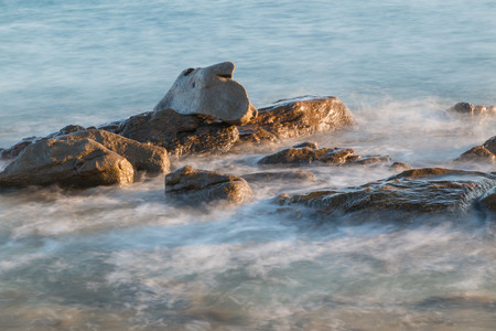 Pictured the stones on the coast with water in motion blur.の写真素材