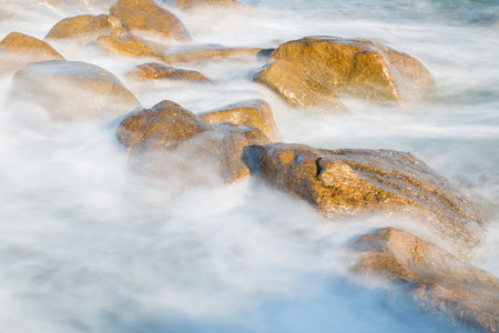Pictured the stones on the coast with water in motion blur.の写真素材