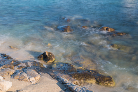 Pictured the stones on the coast with water in motion blur.の写真素材