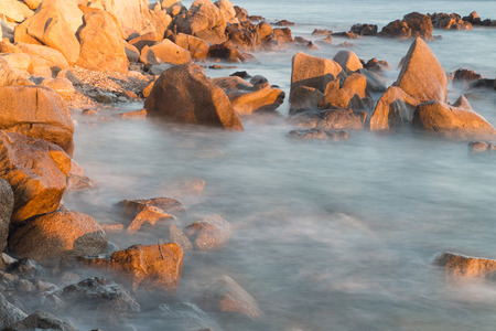 Pictured the stones on the coast with water in motion blur.の写真素材