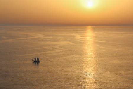 The photograph shows a gold sunset in Santorini.の写真素材