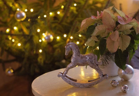 Rocking horse and poinsettia in the Advent periodの写真素材