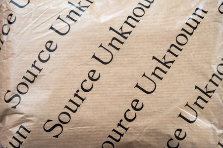 A fashion parcel with trendy clothing in paper packaging with black lettering Source Unknownのeditorial素材
