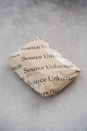 A fashion parcel with trendy clothing in paper packaging with black lettering Source Unknownのeditorial素材