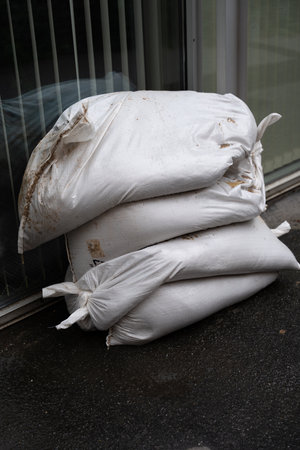 White sandbags at the entrance during flood risk in Prague, Czech Republic in autumnの写真素材