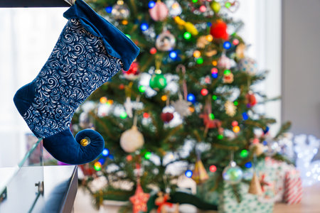 Christmas stocking hanging near a beautifully decorated tree