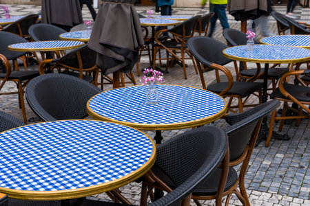 Outdoor cafe tables with blue checkered tablecloths in Pragueの写真素材