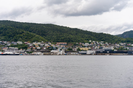 Bergen, Norway - July 6, 2024: Industrial waterfront and hillside housing view in cityのeditorial素材