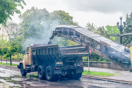 MIRGOROD, UKRAINE : Workers and machines repairs the road. This is standard procedure in Ukraine after winter.のeditorial素材