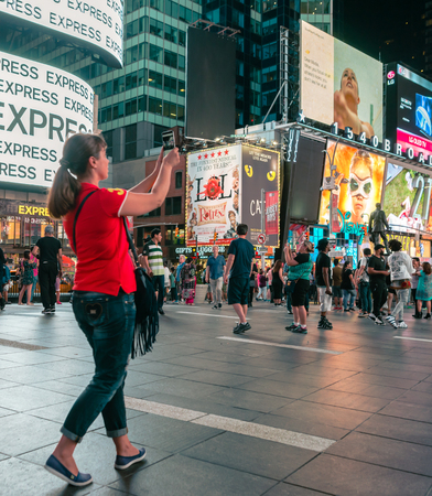 NEW YORK CITY, USA: Buildings and street life on the Times Square - one of the world's most visited tourist attractions, drawing an estimated 50 million visitors annually. Lowlight.のeditorial素材