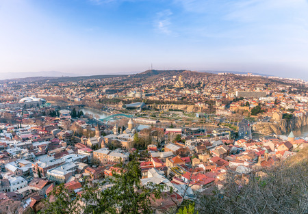 Panorama of Tbilisi, Georgia in sunset rays. Vivid, saturated, splittoned image.