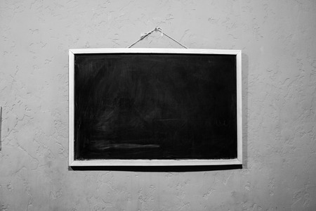 Blackboard on the wall in artificial lightの写真素材