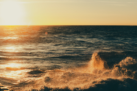 Monstrous sea storm waves in sunset warm raysの写真素材