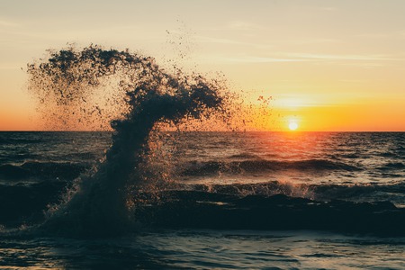 Monstrous sea storm waves in sunset warm raysの写真素材