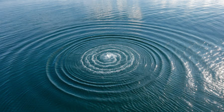 Water disturbances create expansive ripples on the surface, reflecting sunlight. The calm lake environment enhances the peaceful atmosphere, inviting relaxation and contemplation.の写真素材