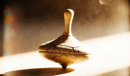 A beautifully crafted spinning top with intricate cracks stands balanced, illuminated by warm...