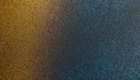Golden and blue hues mix beautifully on a textured surface, creating a stunning visual effect. Soft light enhances the colors, inviting closer exploration of the intricate patterns.の写真素材
