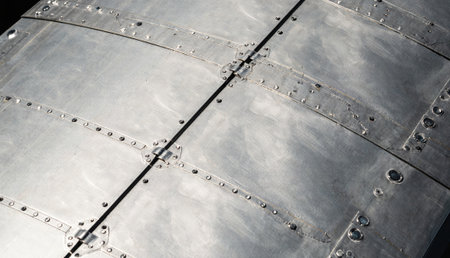 Shiny metal sheets glisten in the sunlight, revealing the careful craftsmanship of an aircraft....