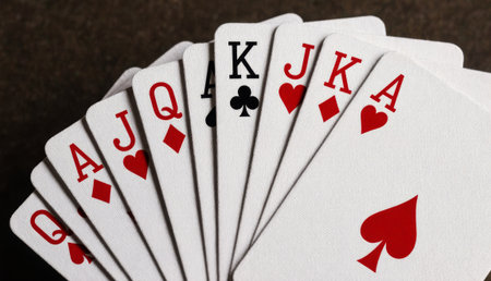 A vibrant fan of playing cards showcases kings, queens, and aces, symbolizing strategy and chance...